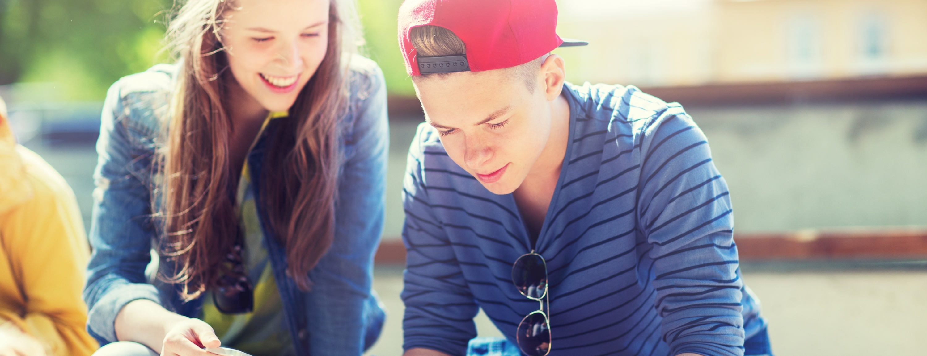 technology, internet and people concept - happy teenage friends with smartphones outdoors